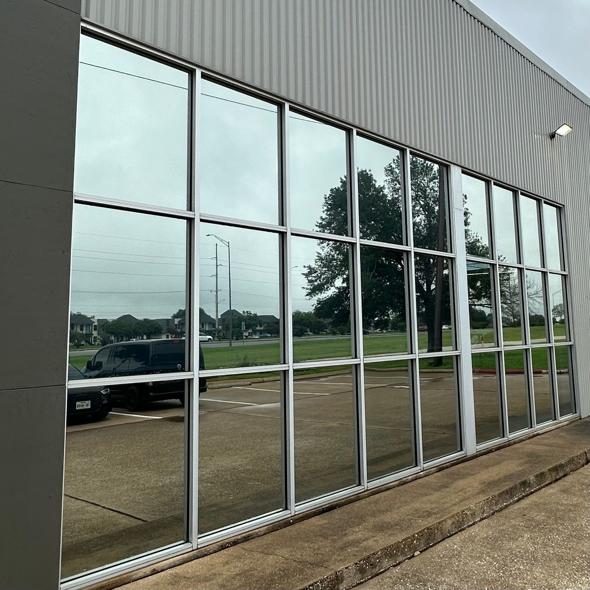 A van is reflected in the windows of a building