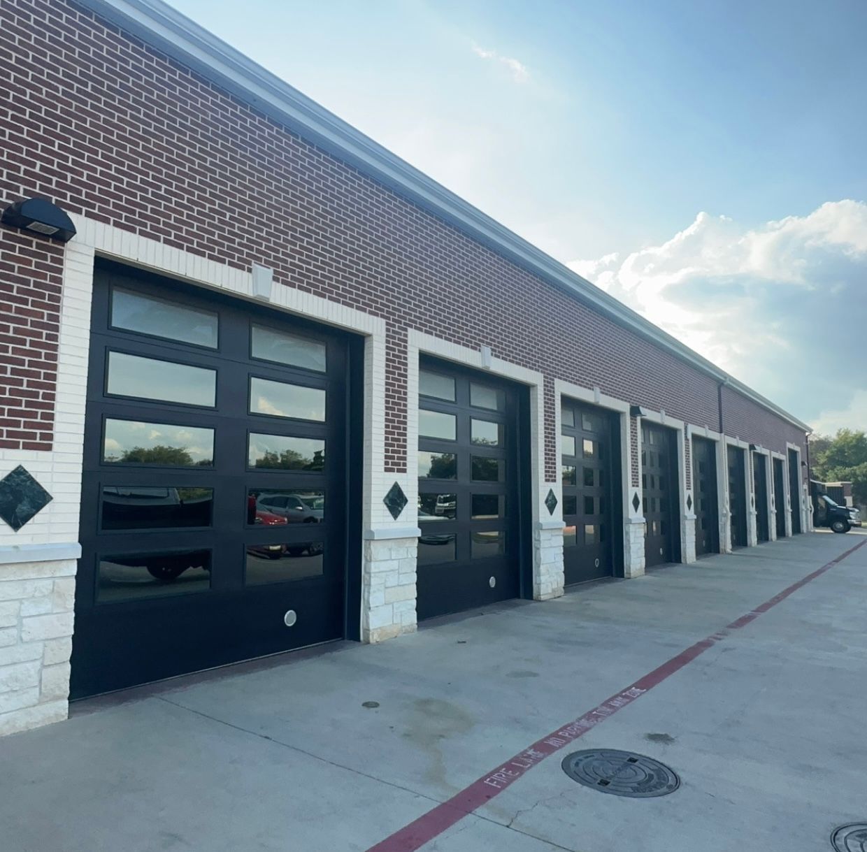 A row of garage doors on a brick building