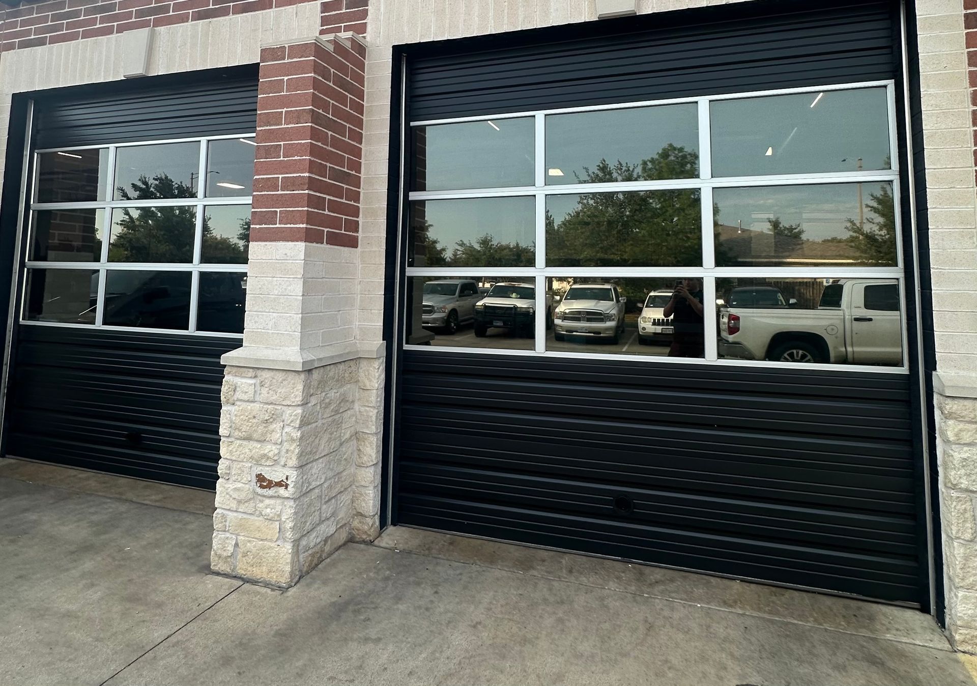 A black garage door with a lot of windows