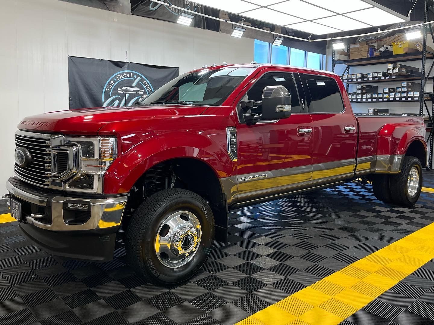 a red pickup truck is parked in a garage .