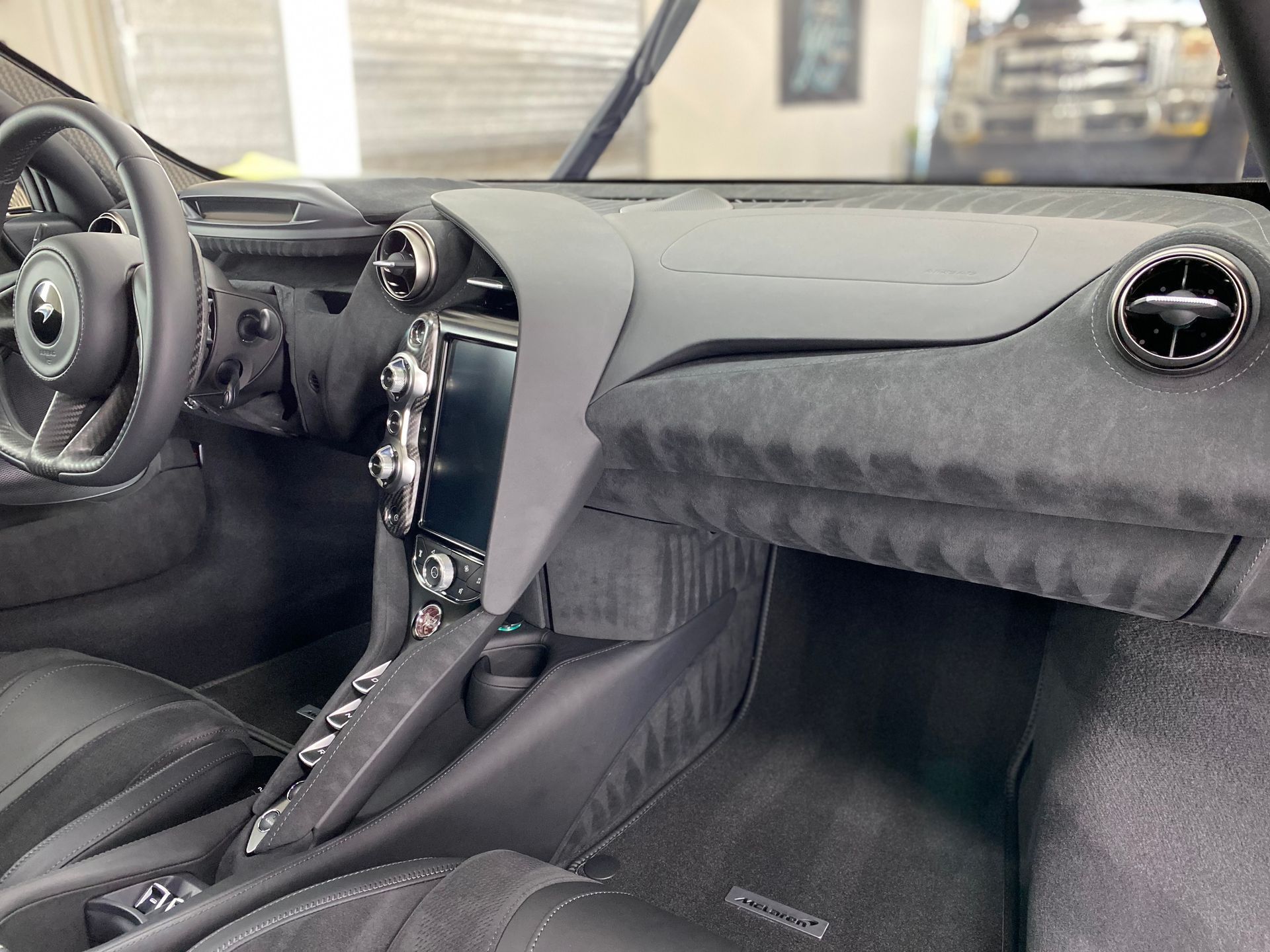 the interior of a car with a steering wheel and dashboard .