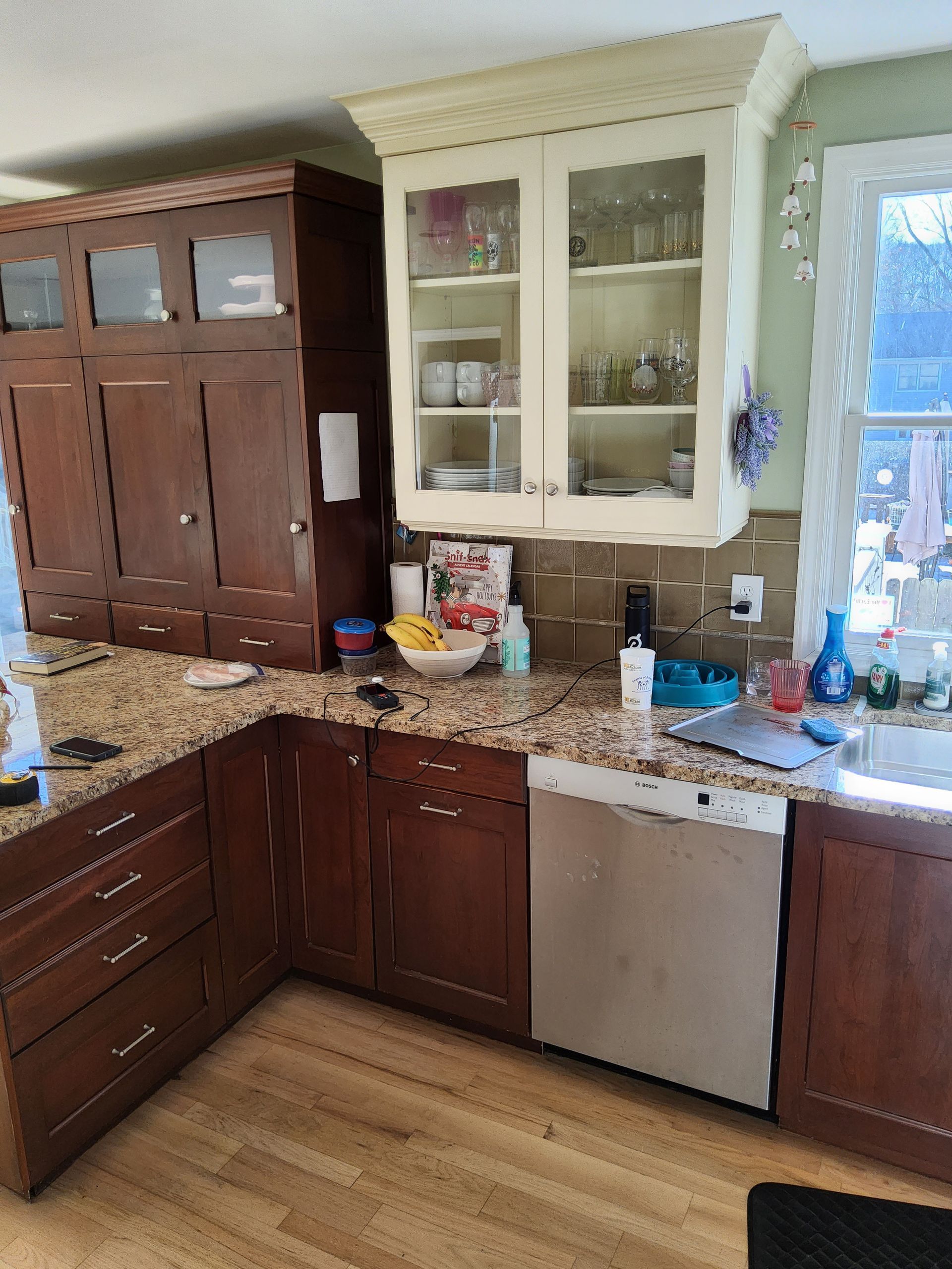 A kitchen with wooden cabinets and granite counter tops