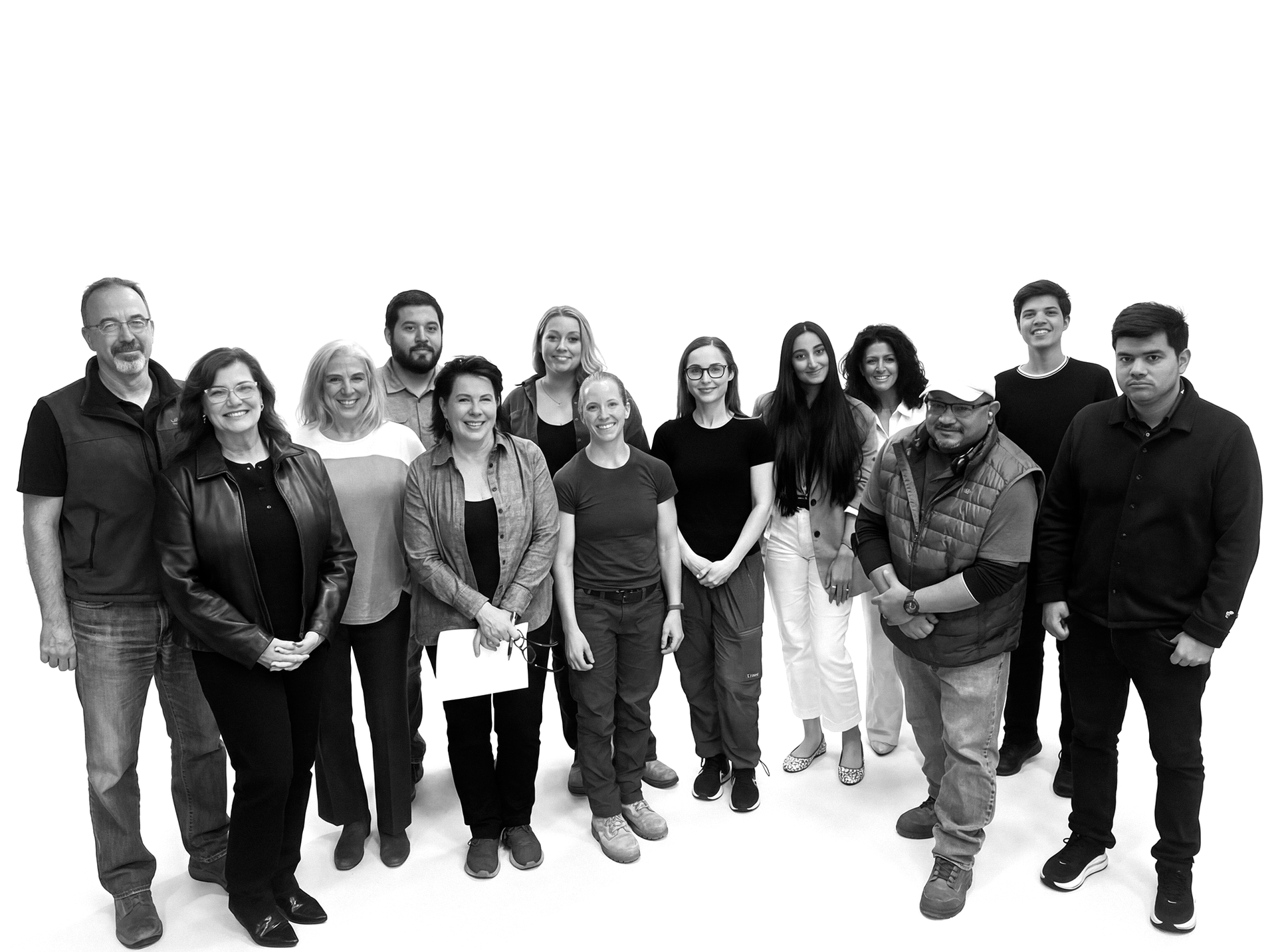 Group of people standing together, looking at the camera against a white backdrop.