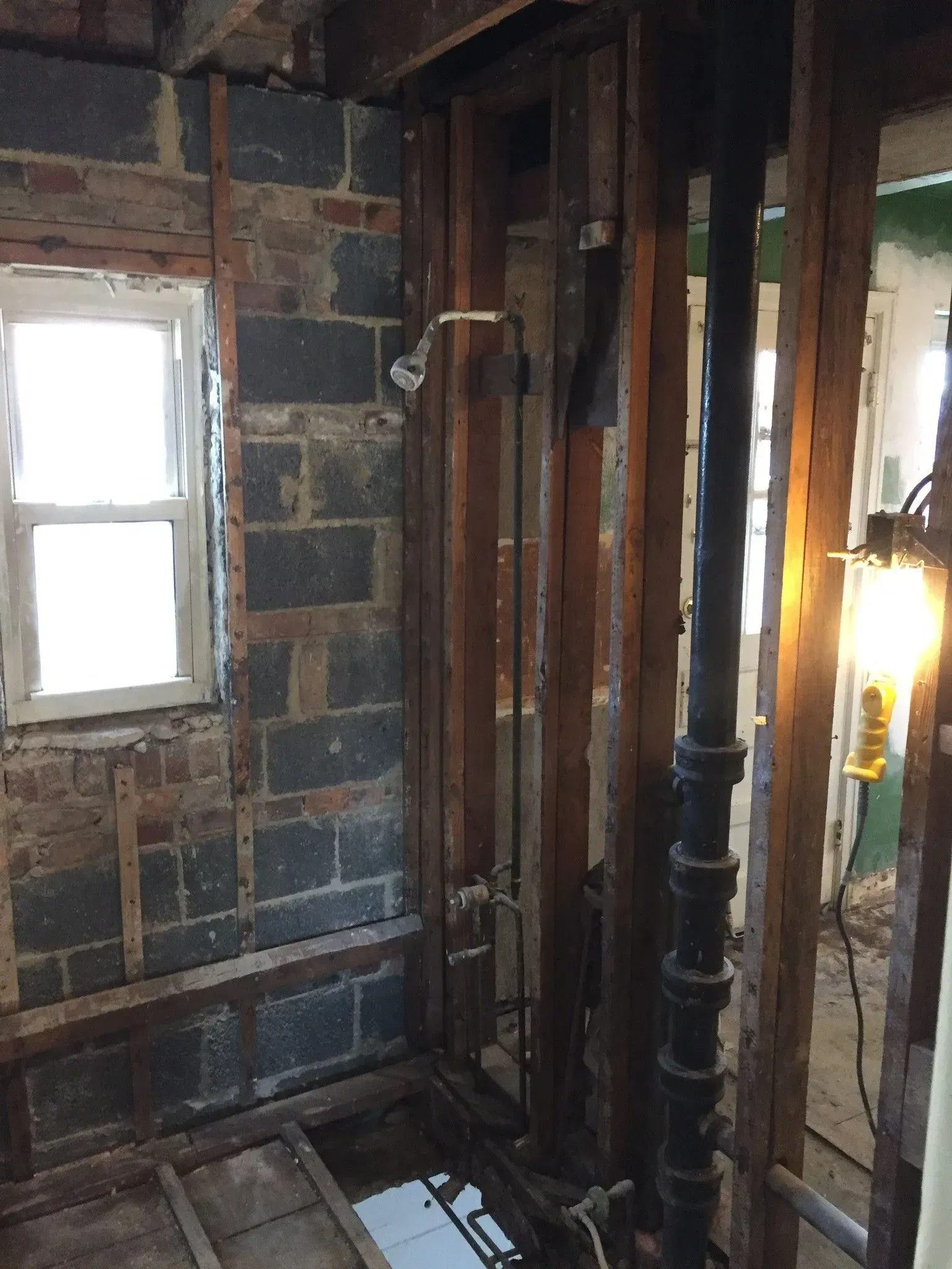 A room with brick walls and wooden beams and a window