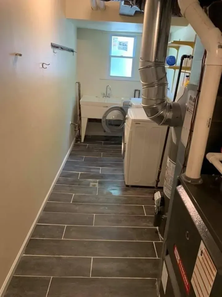 A laundry room with a washer and dryer and a furnace.