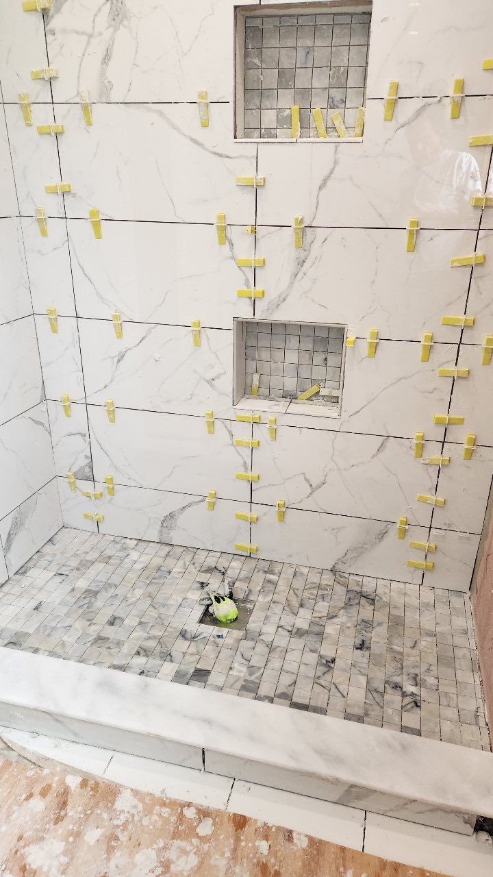 A shower stall is being built in a bathroom.