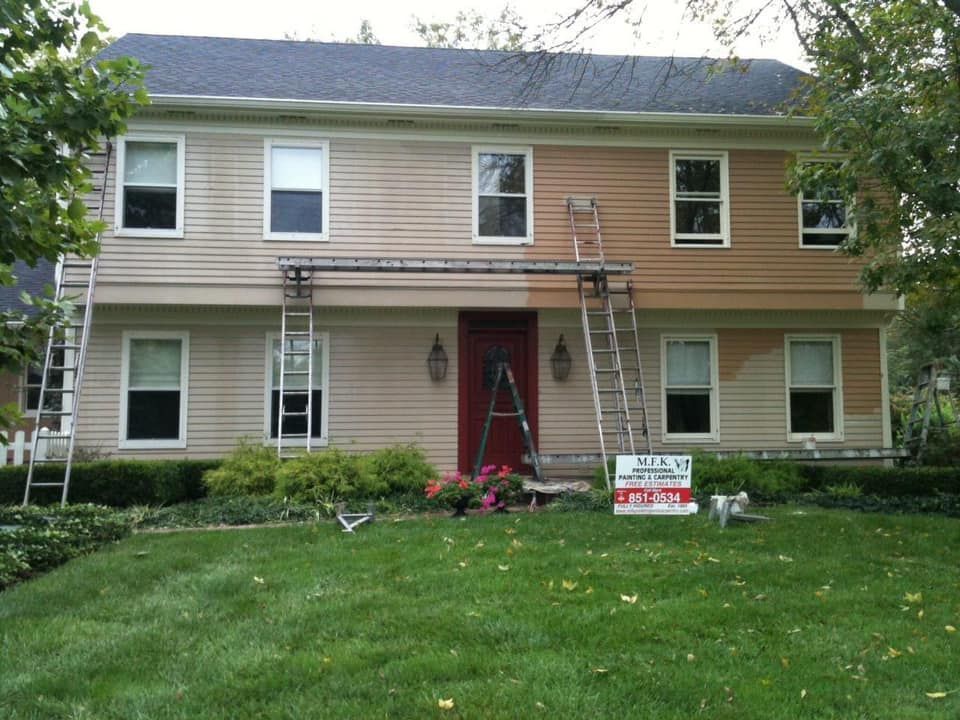 A house that is being painted with a sign that says ' painting ' on it