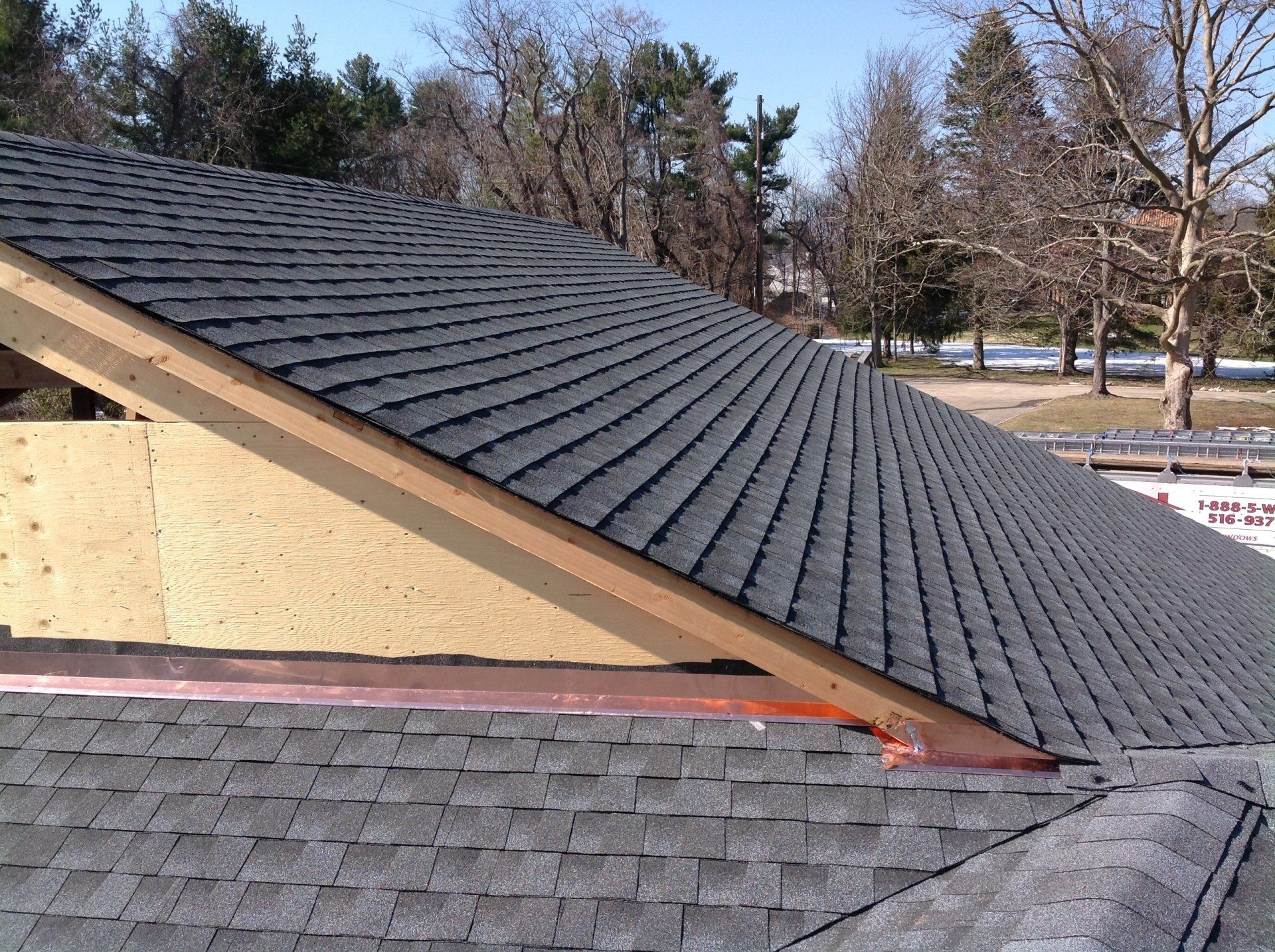 The roof of a house is being built and has shingles on it