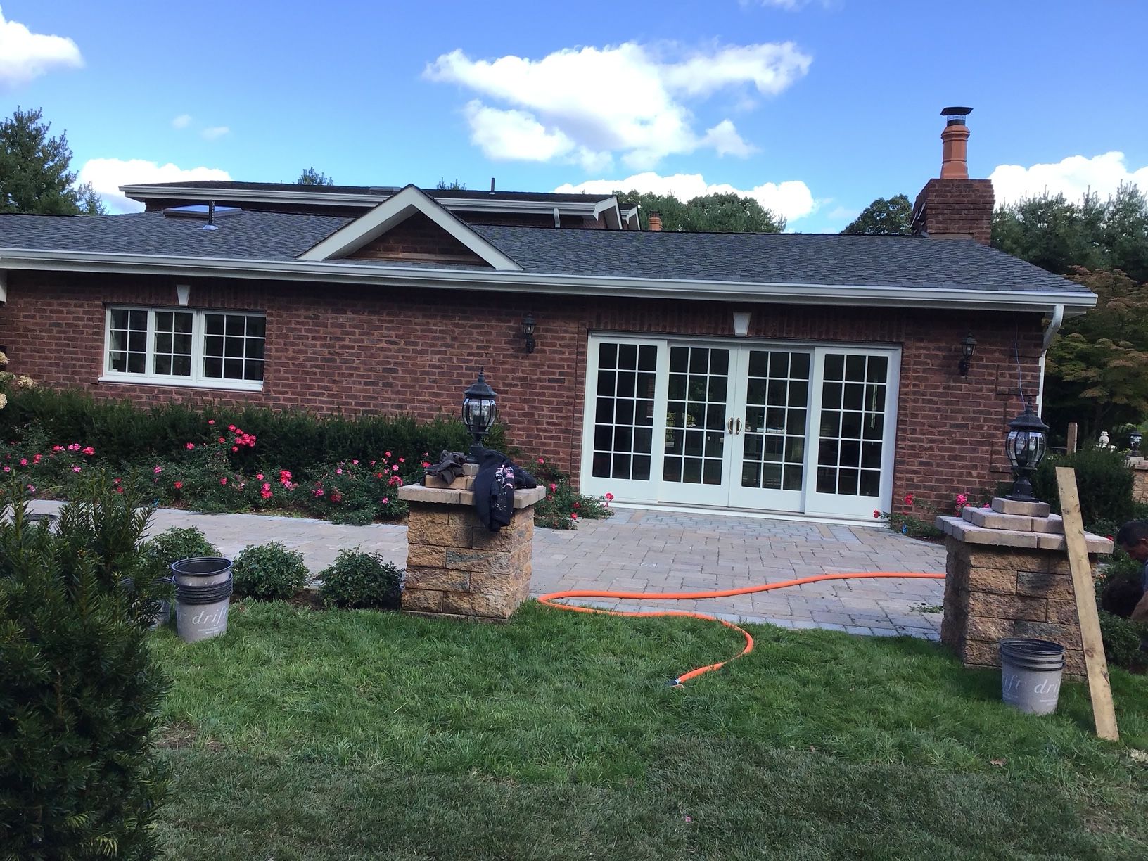A brick house with a gray roof and a lot of windows