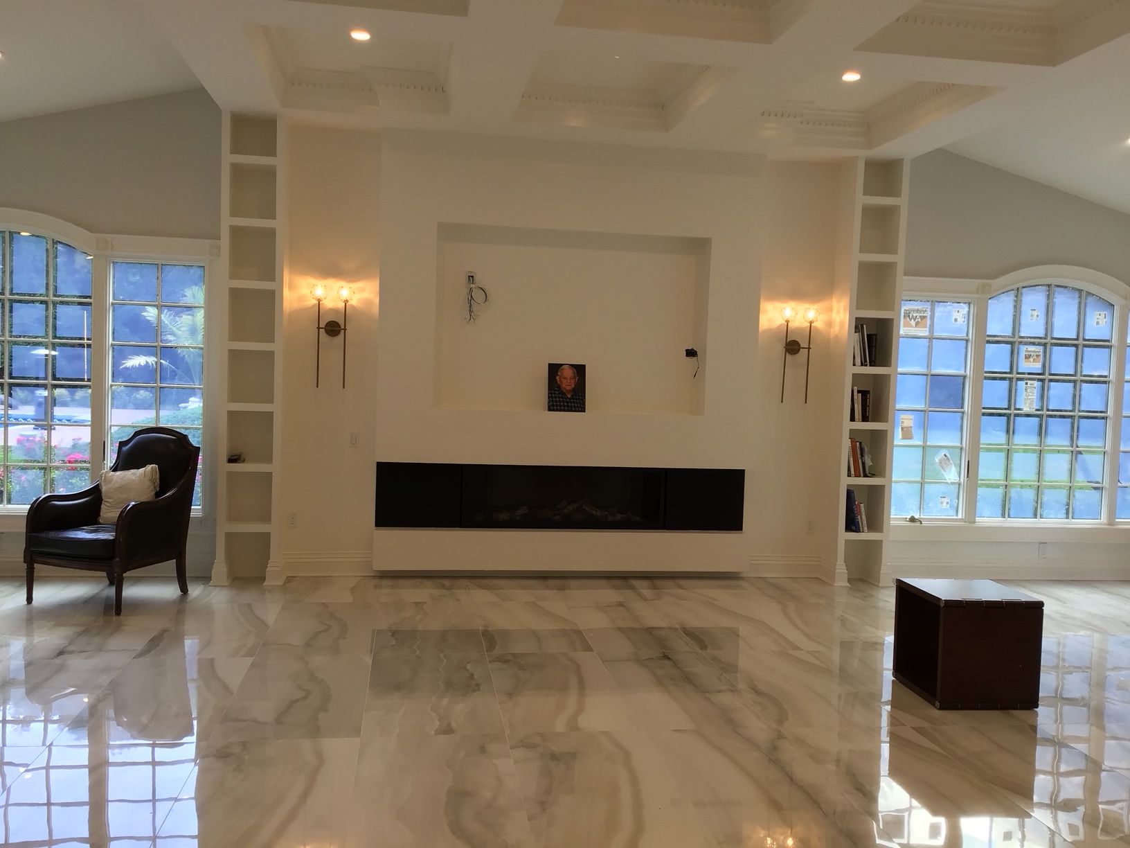 A living room with a fireplace and a chair