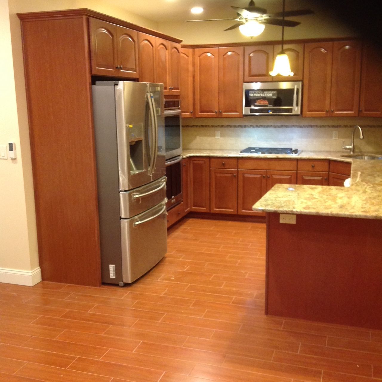 A kitchen with stainless steel appliances and wooden cabinets