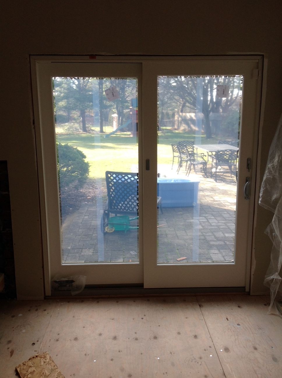 A room with a sliding glass door that looks out onto a patio.