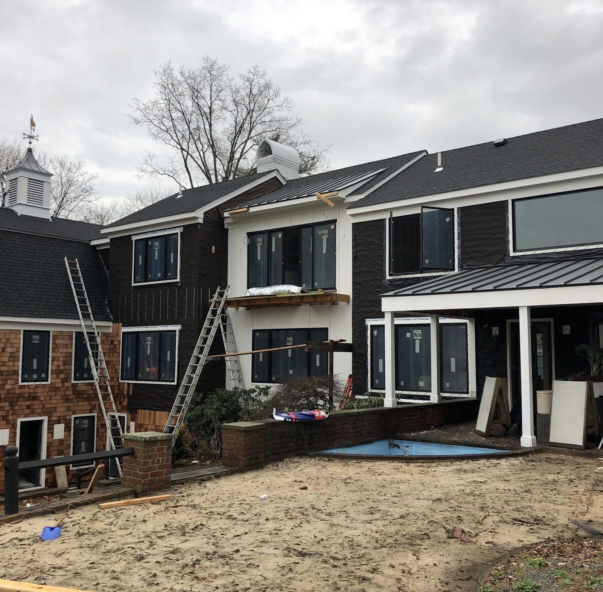 A large house with a lot of windows is under construction