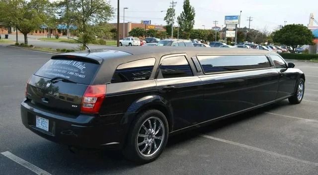 Black stretch limousine parked in a lot on a sunny day