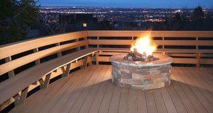 Wooden deck with benches and fireplace