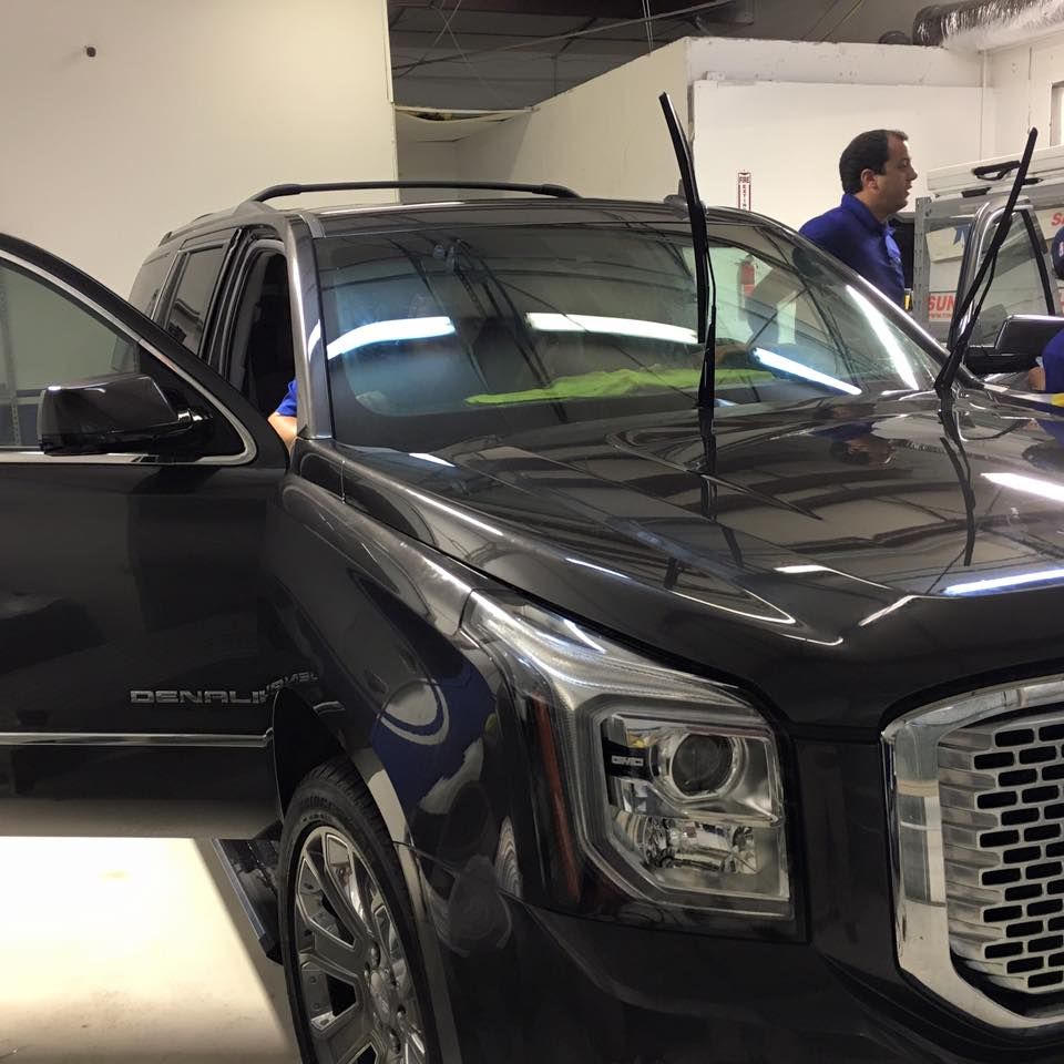 a black denali suv is parked in a garage