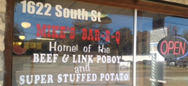 Sign for Miki's Bar-B-Q at 1622 South St, advertising beef & link poboys and super stuffed potatoes.
