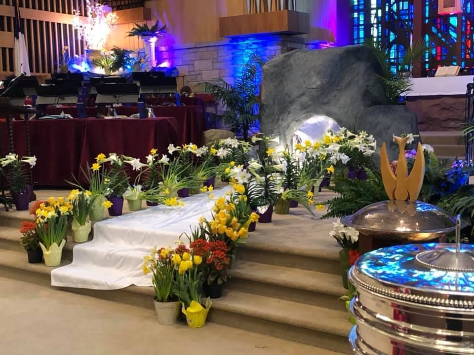 Decorated stairs with white drapery and yellow flowers at an indoor event venue