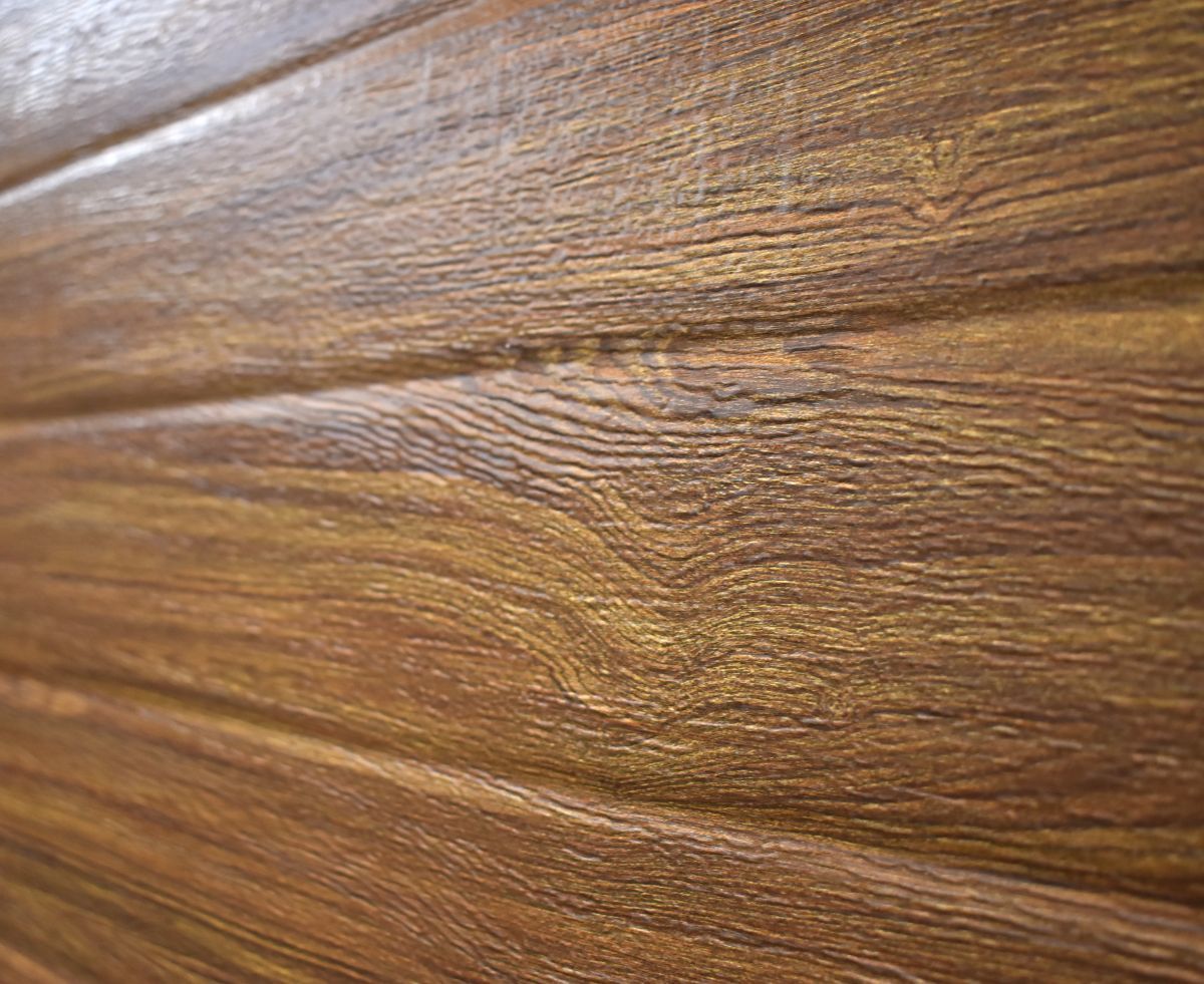 Wooden paneling with a brown and gold wood grain pattern.