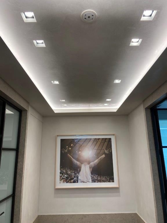 Hallway with a framed picture under recessed lighting and a smoke detector on the ceiling.