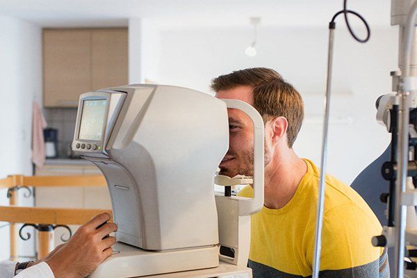 Checking eye condition of man