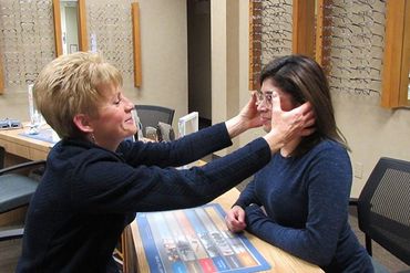 Putting eyeglass on patient