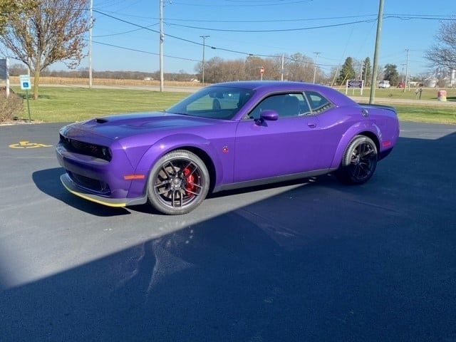 Purple Dodge Challenger parked on pavement.