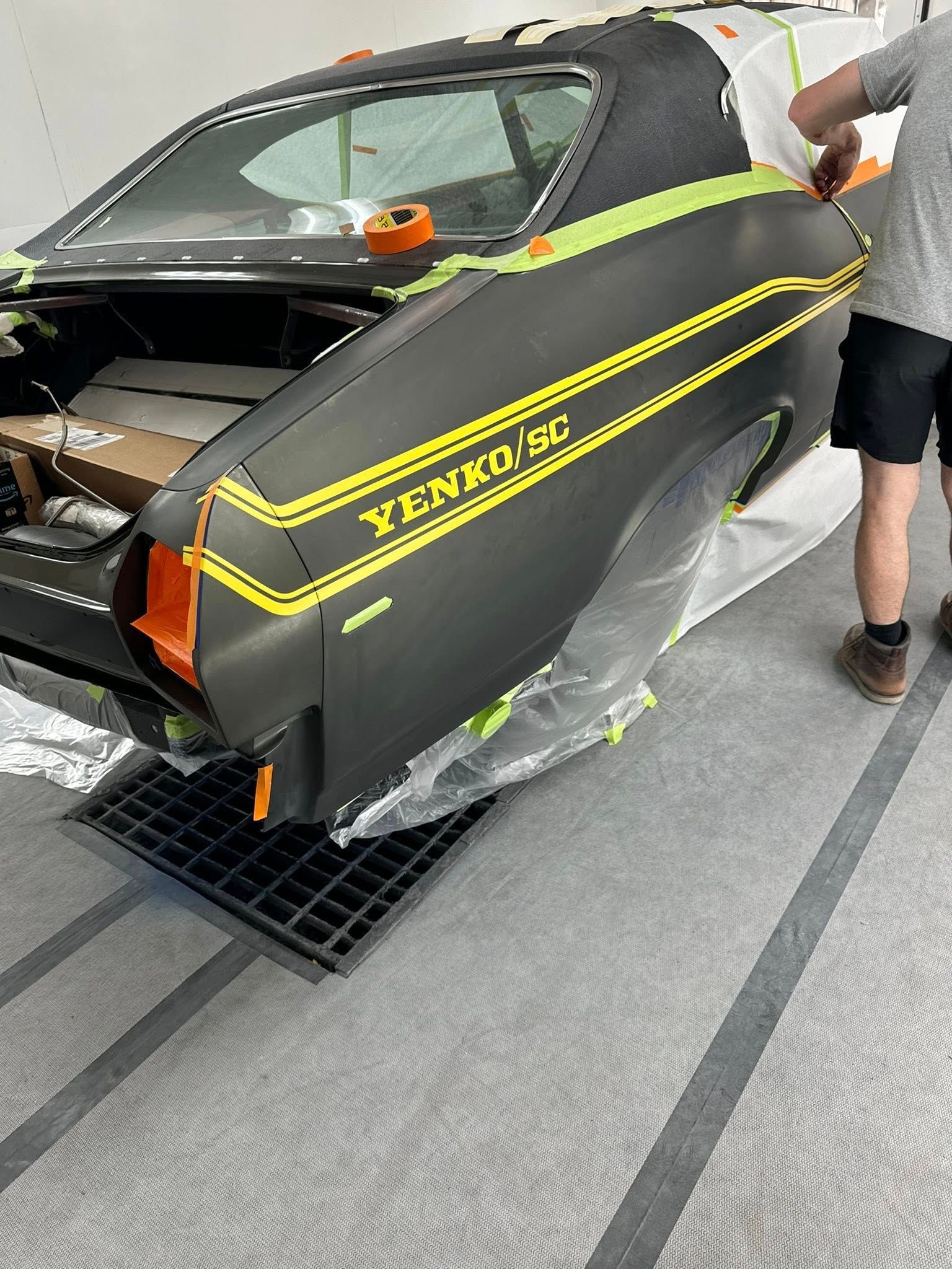 Black car with yellow stripes and 