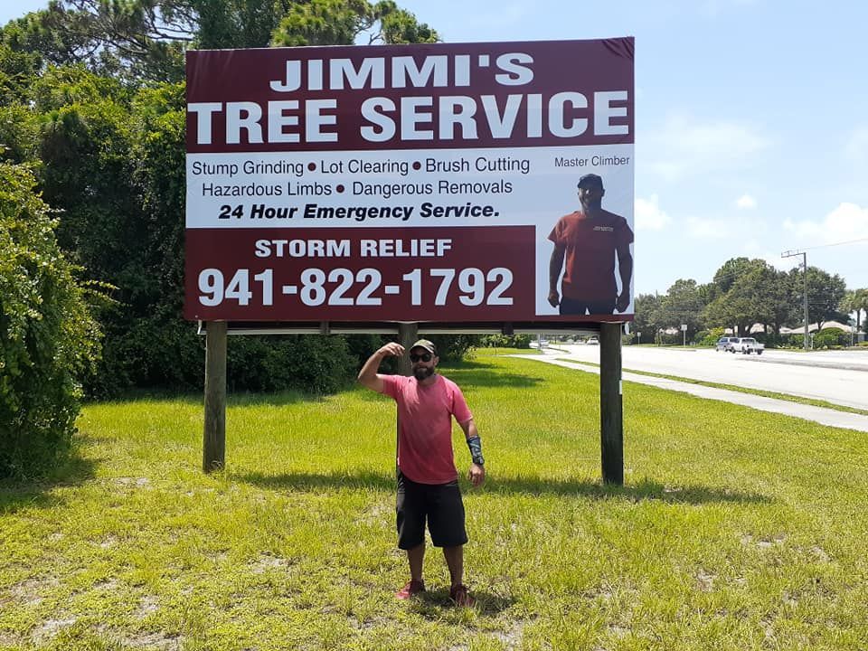 a man is standing in front of a Jimmi's Tree Service billboard