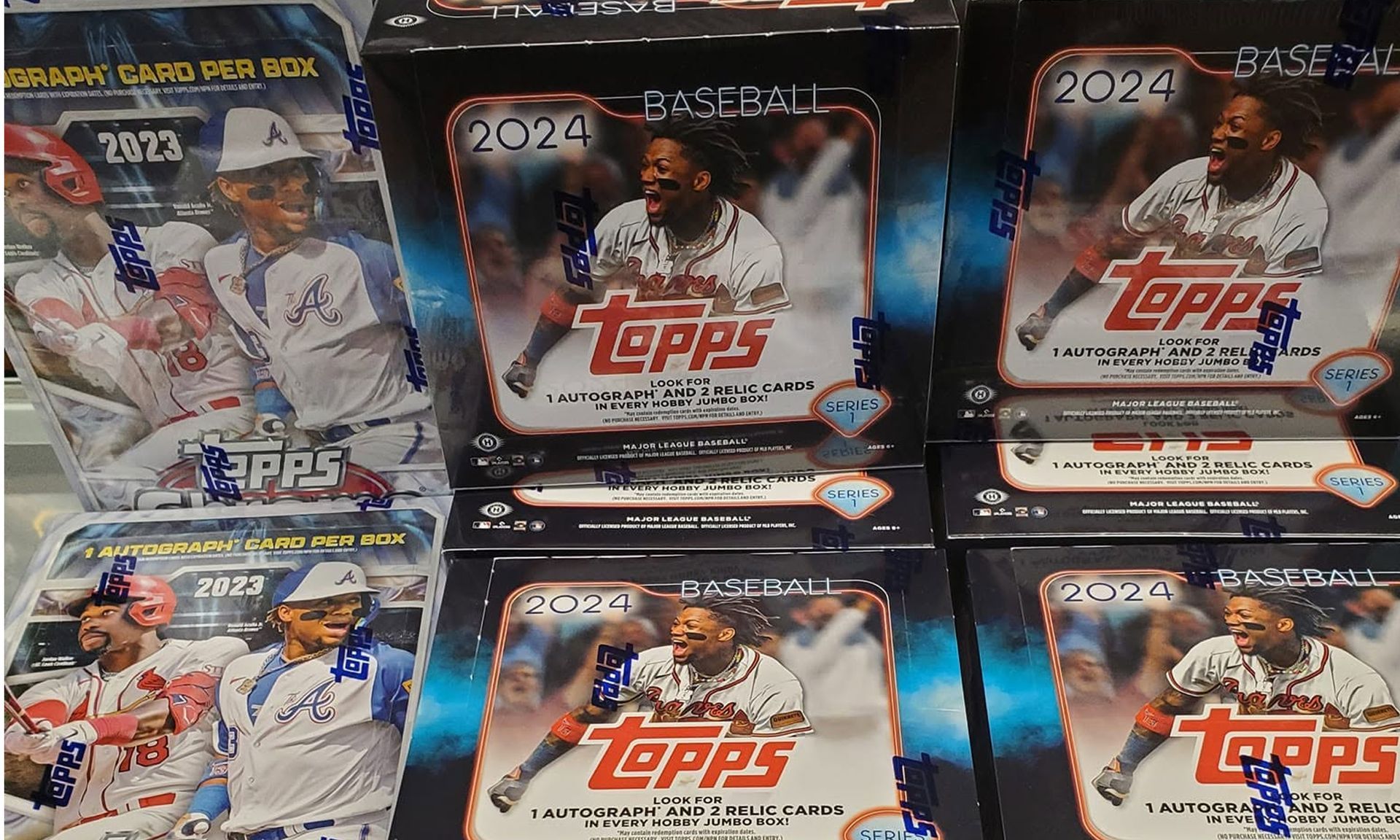 Display of 2024 Topps baseball trading card boxes on a store shelf.