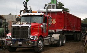Red truck with crane for recycling