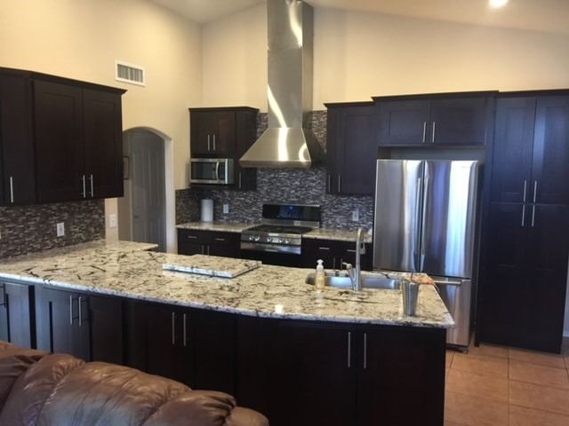 A kitchen with stainless steel appliances and granite counter tops