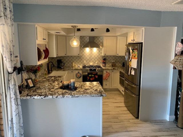 A kitchen with stainless steel appliances and granite counter tops.