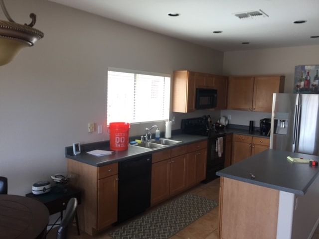 A kitchen with a bucket that says ' bucket ' on it