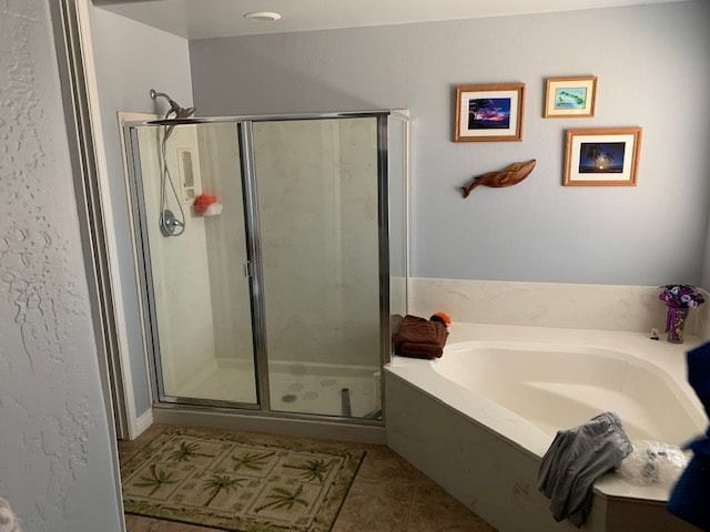 A bathroom with a tub , shower , and picture on the wall.