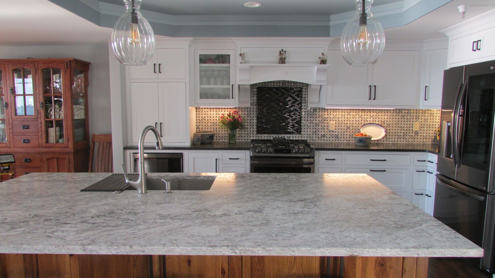 White kitchen with rustic Hickory island