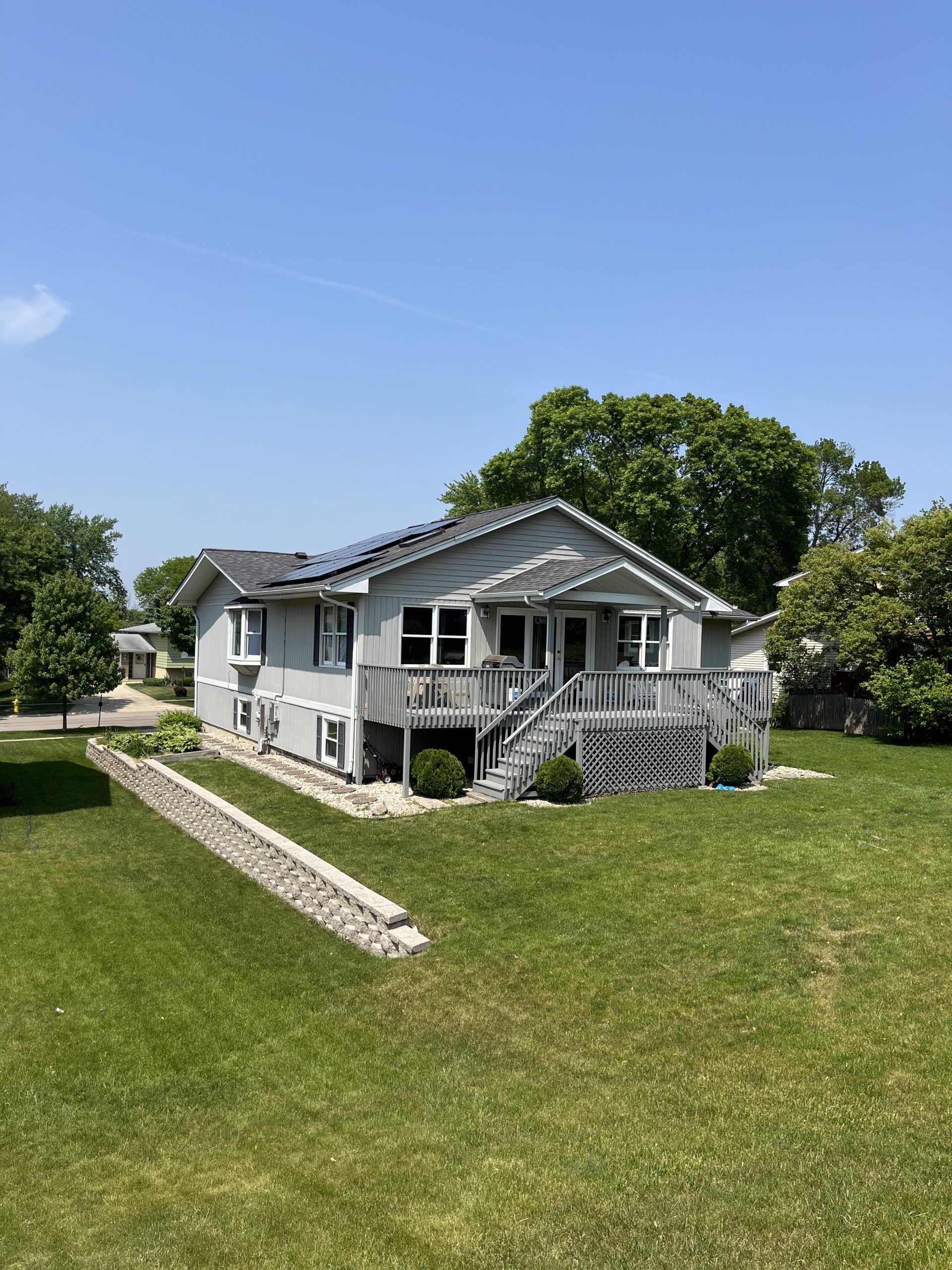 A large white house with a large lawn in front of it.