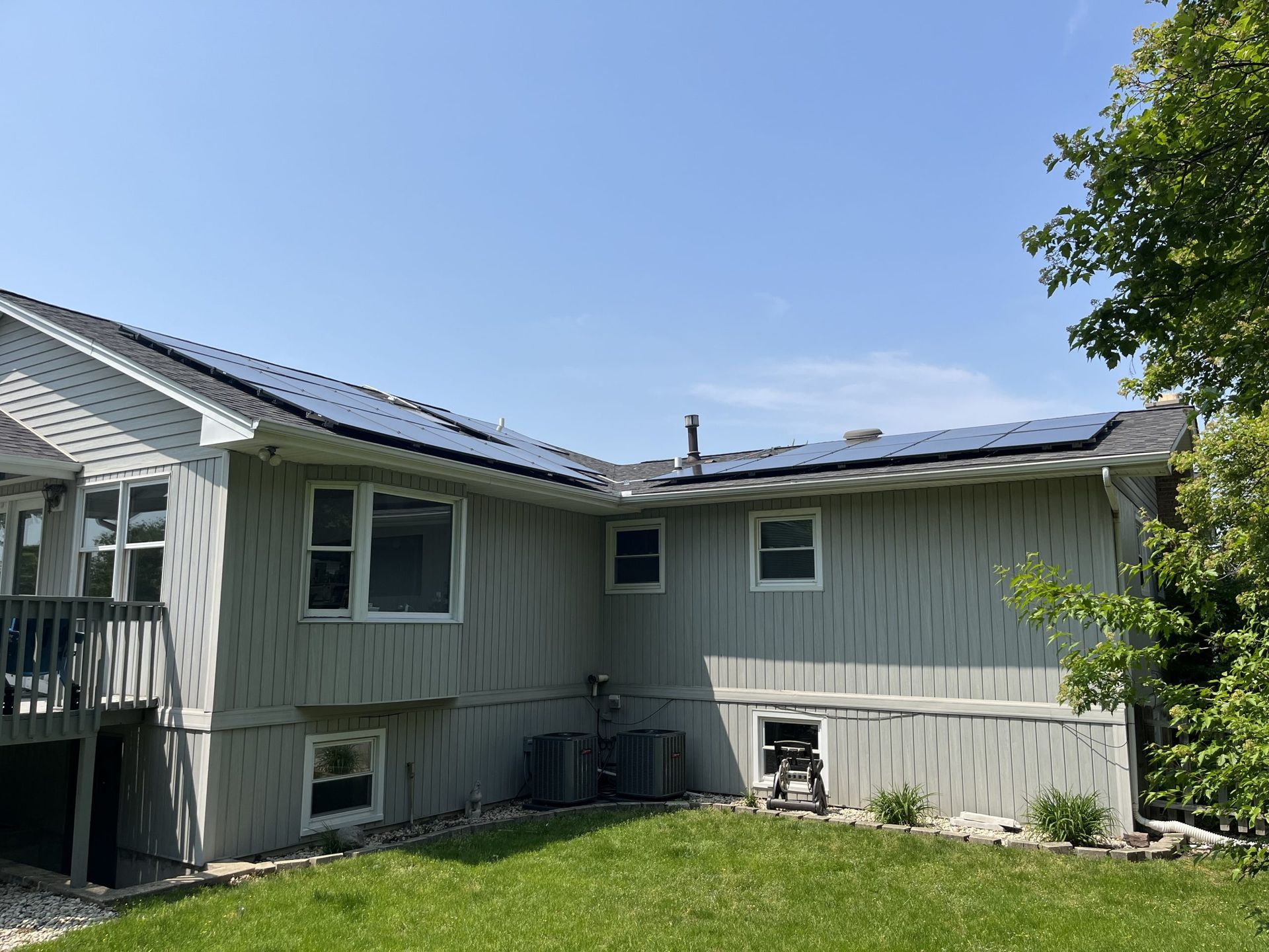The back of a house with solar panels on the roof.