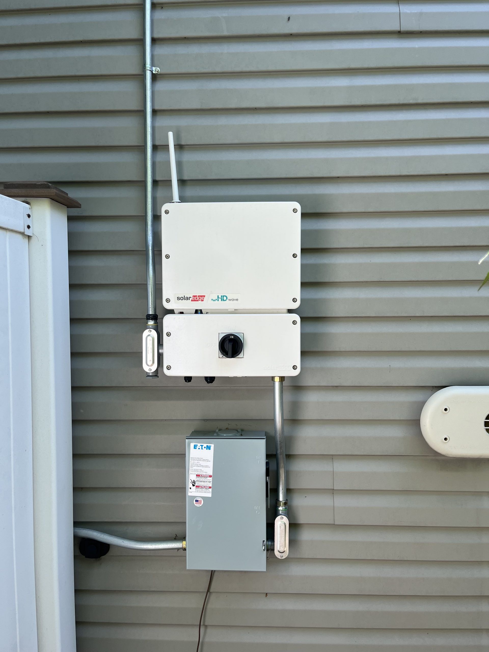 A white box is attached to the side of a building