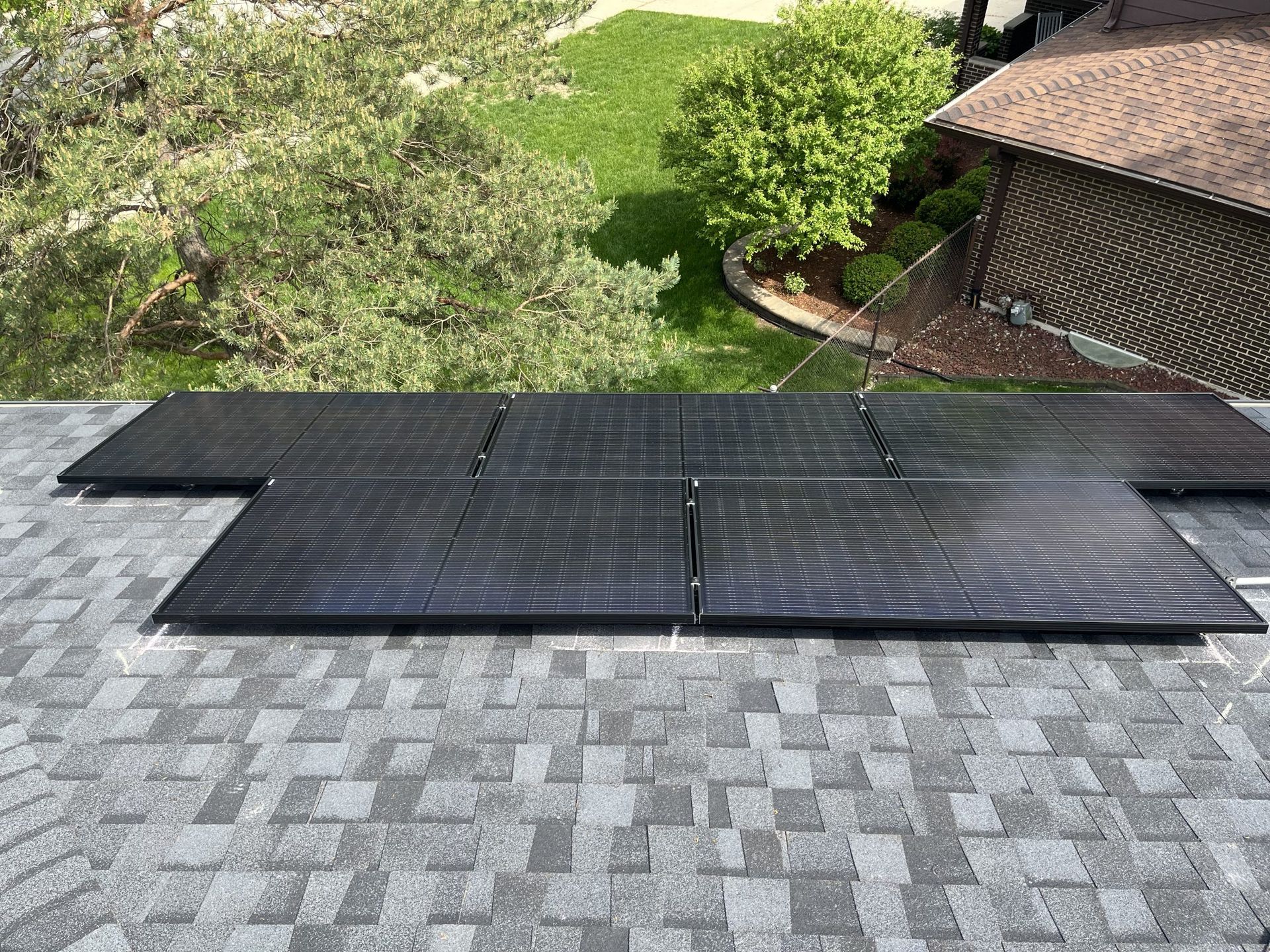 A bunch of solar panels are sitting on top of a roof.