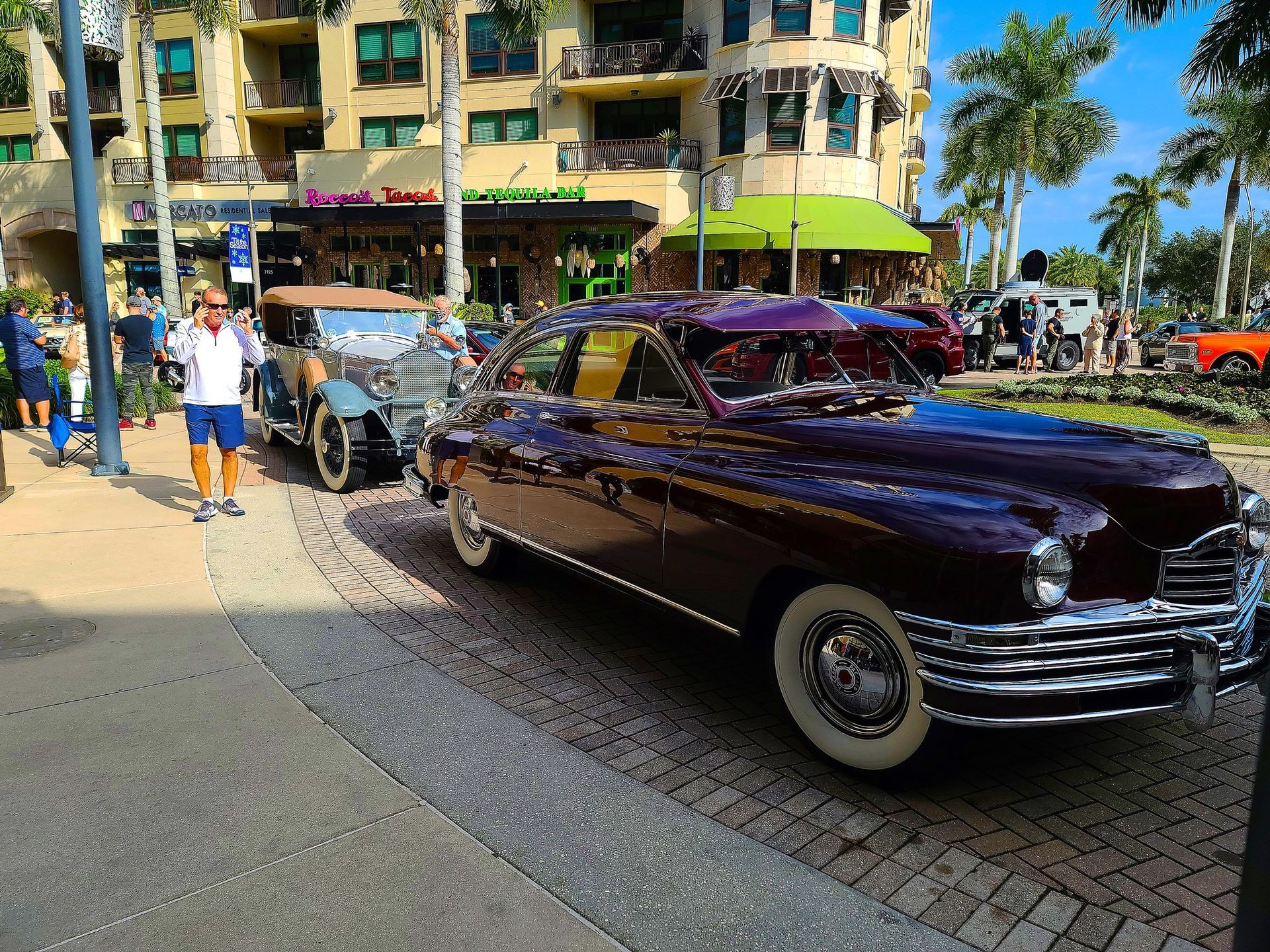 A purple car is parked on the side of the road