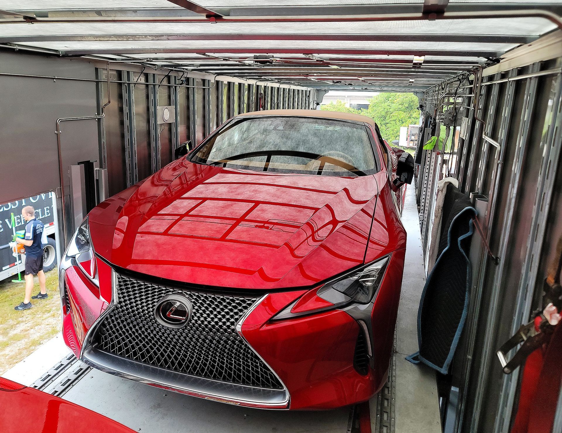 A red car is parked inside of a building.