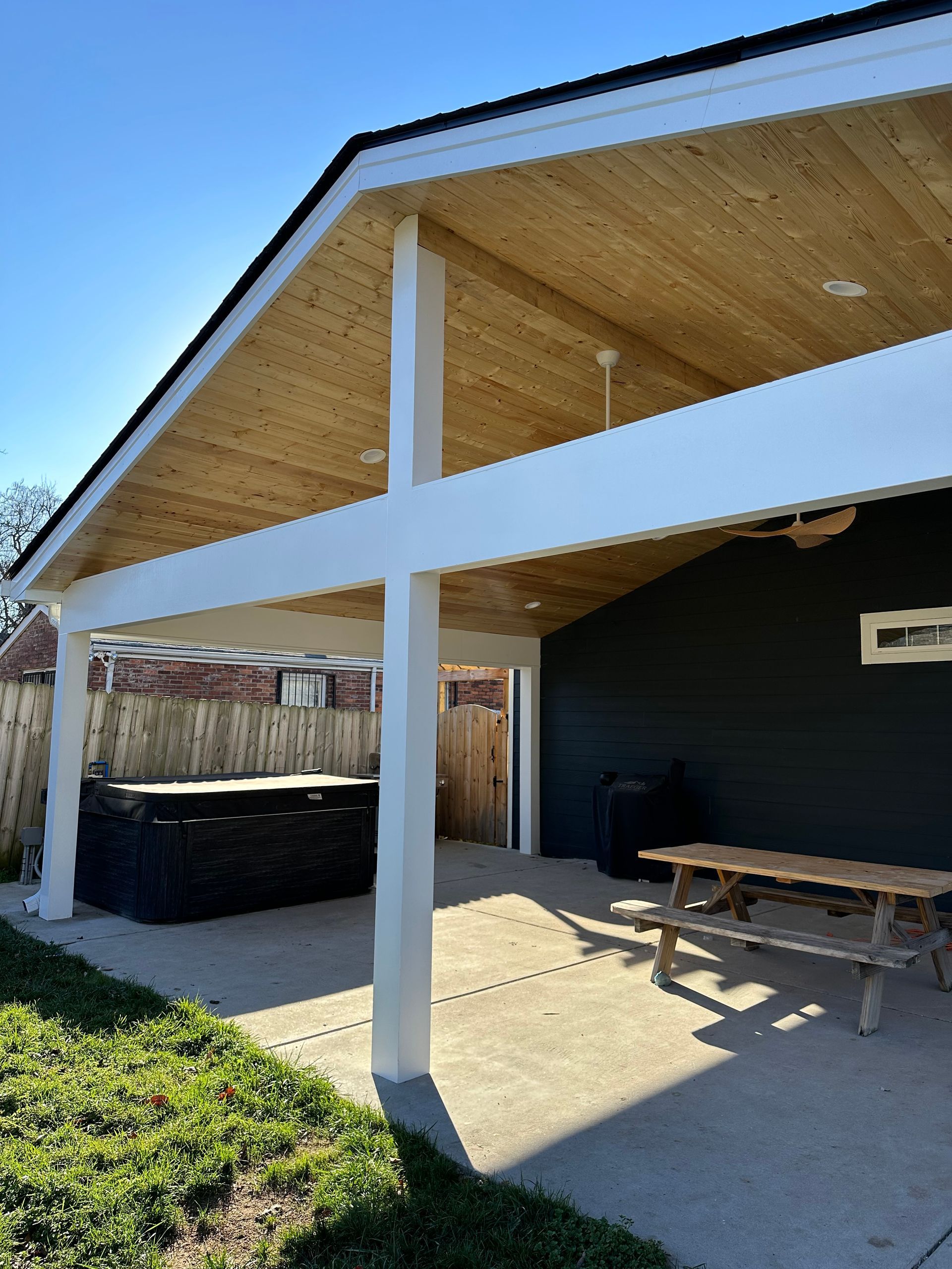 A house with a wooden roof and a picnic table