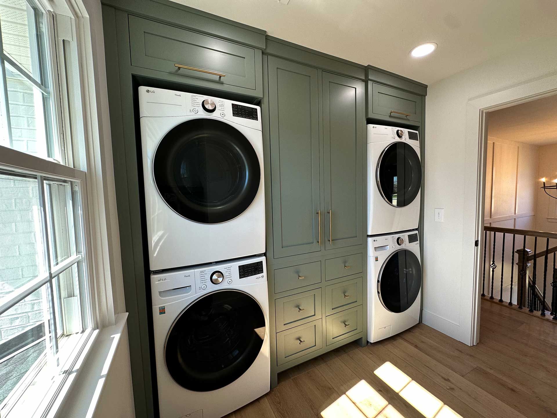 A laundry room with a washer and dryer stacked on top of each other.