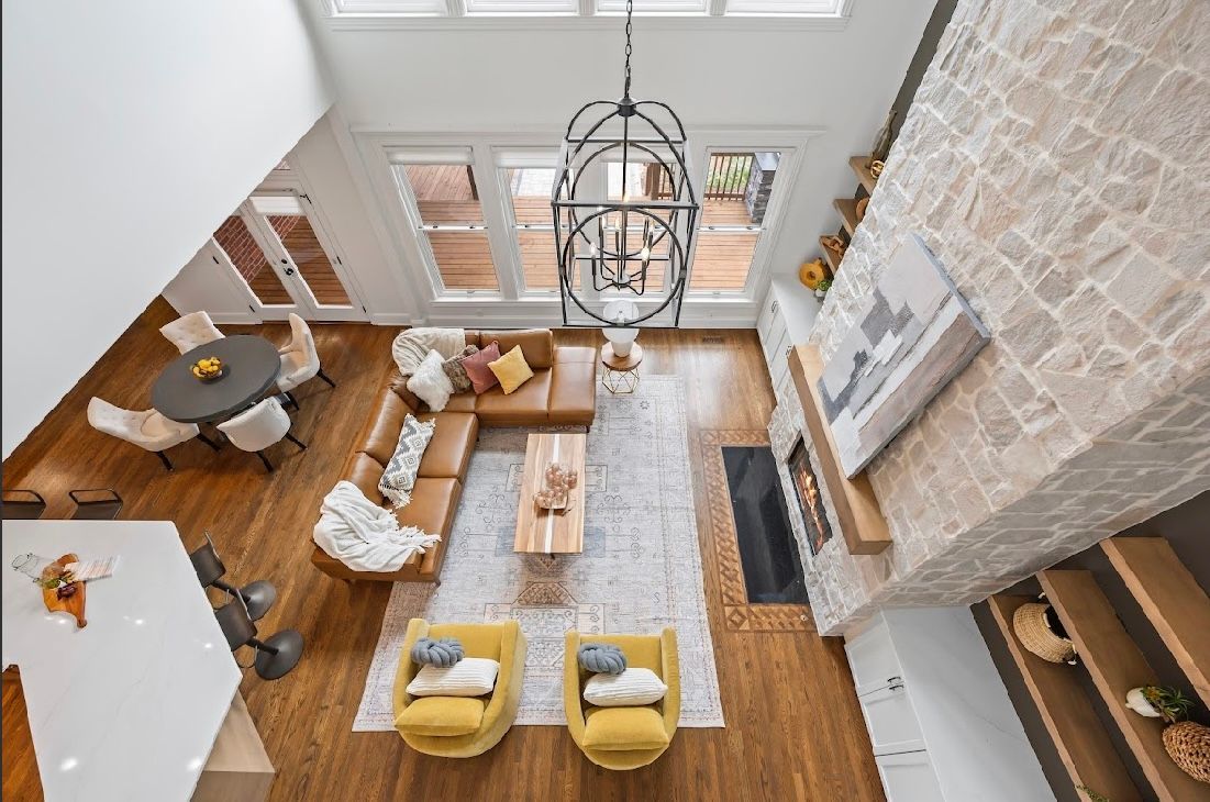 An aerial view of a living room filled with furniture and a fireplace.