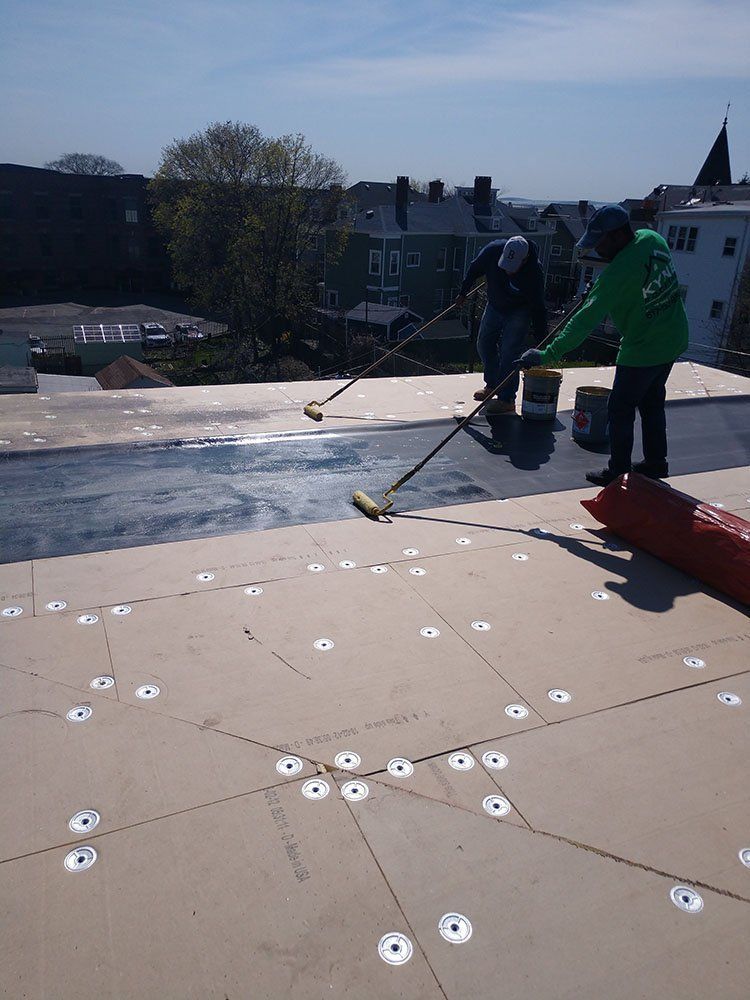 Kyne Roofing & Construction people waterproof coating on roof