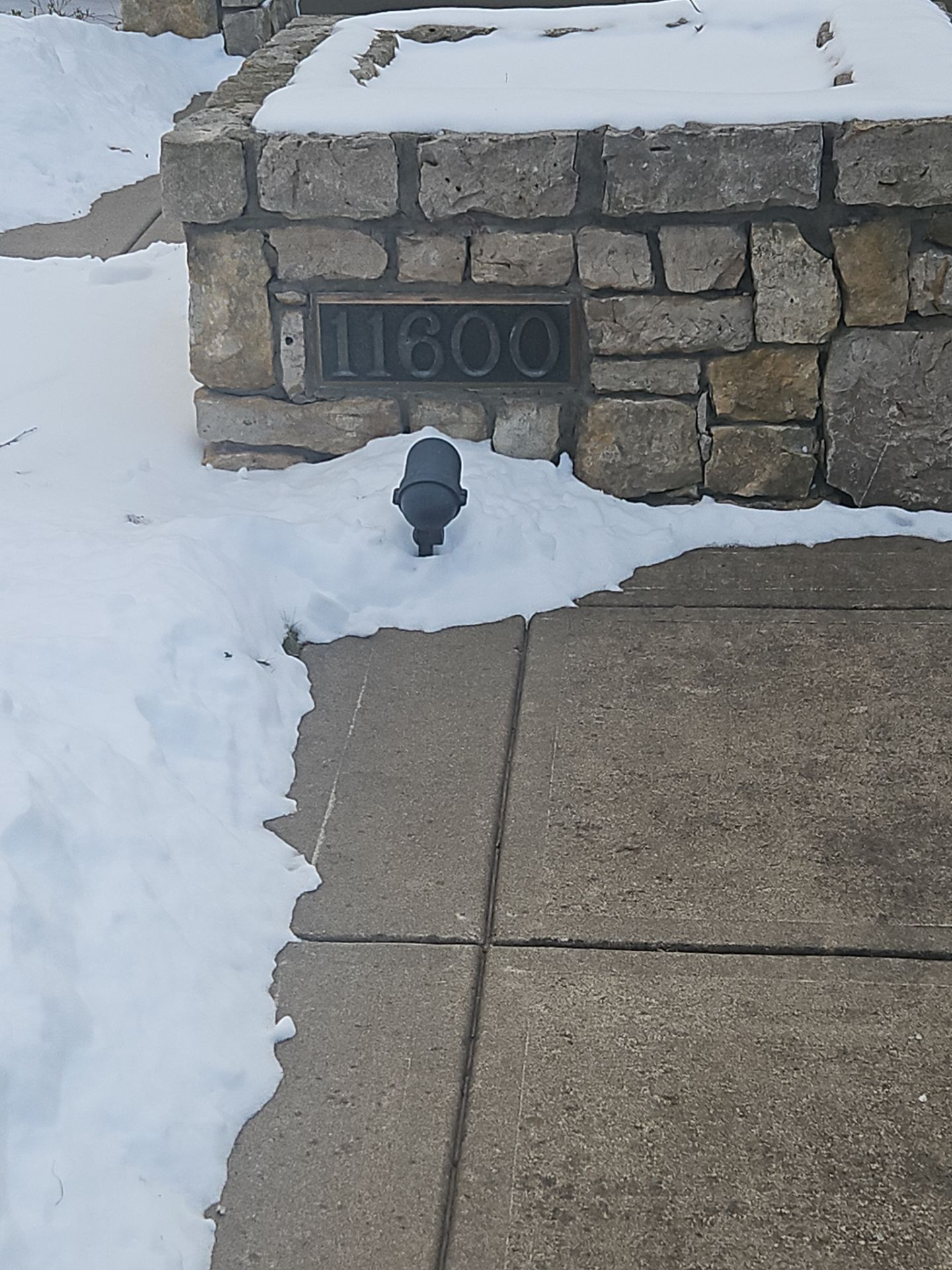 Stone wall with address plaque 