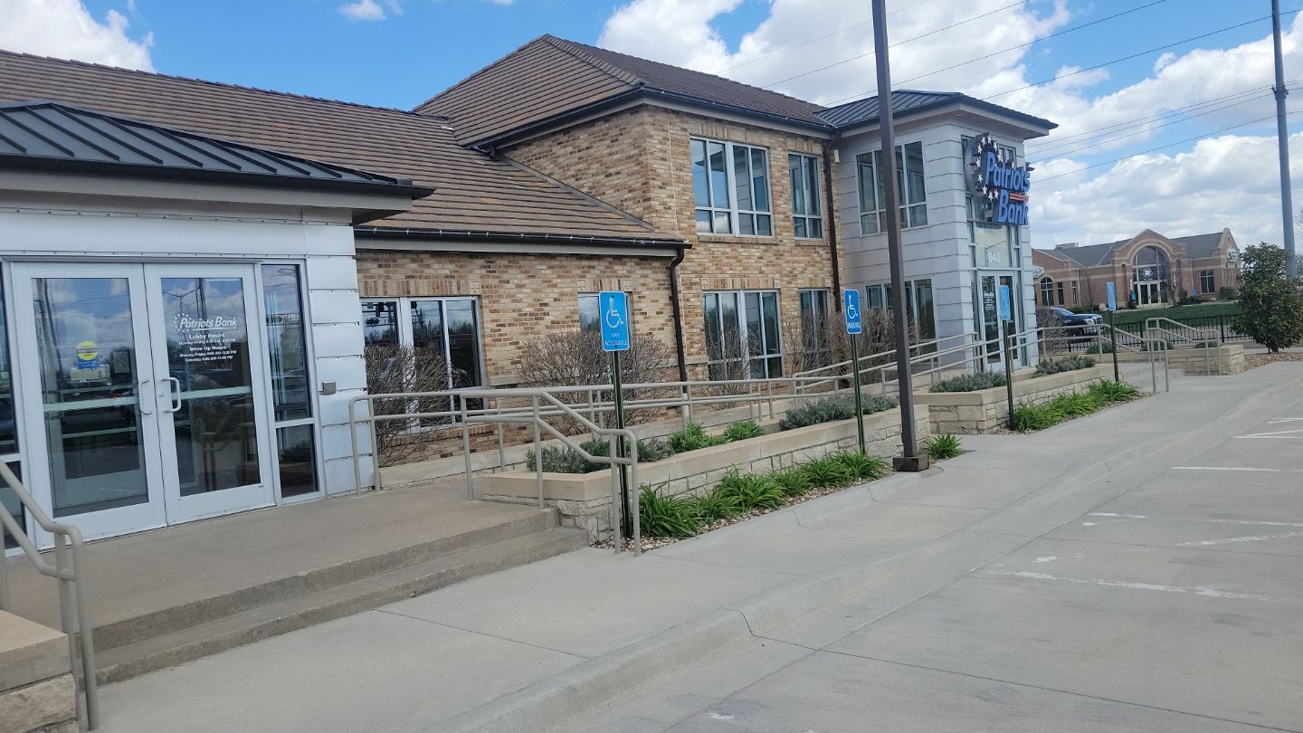 Building exterior with accessible ramp and handicap parking.