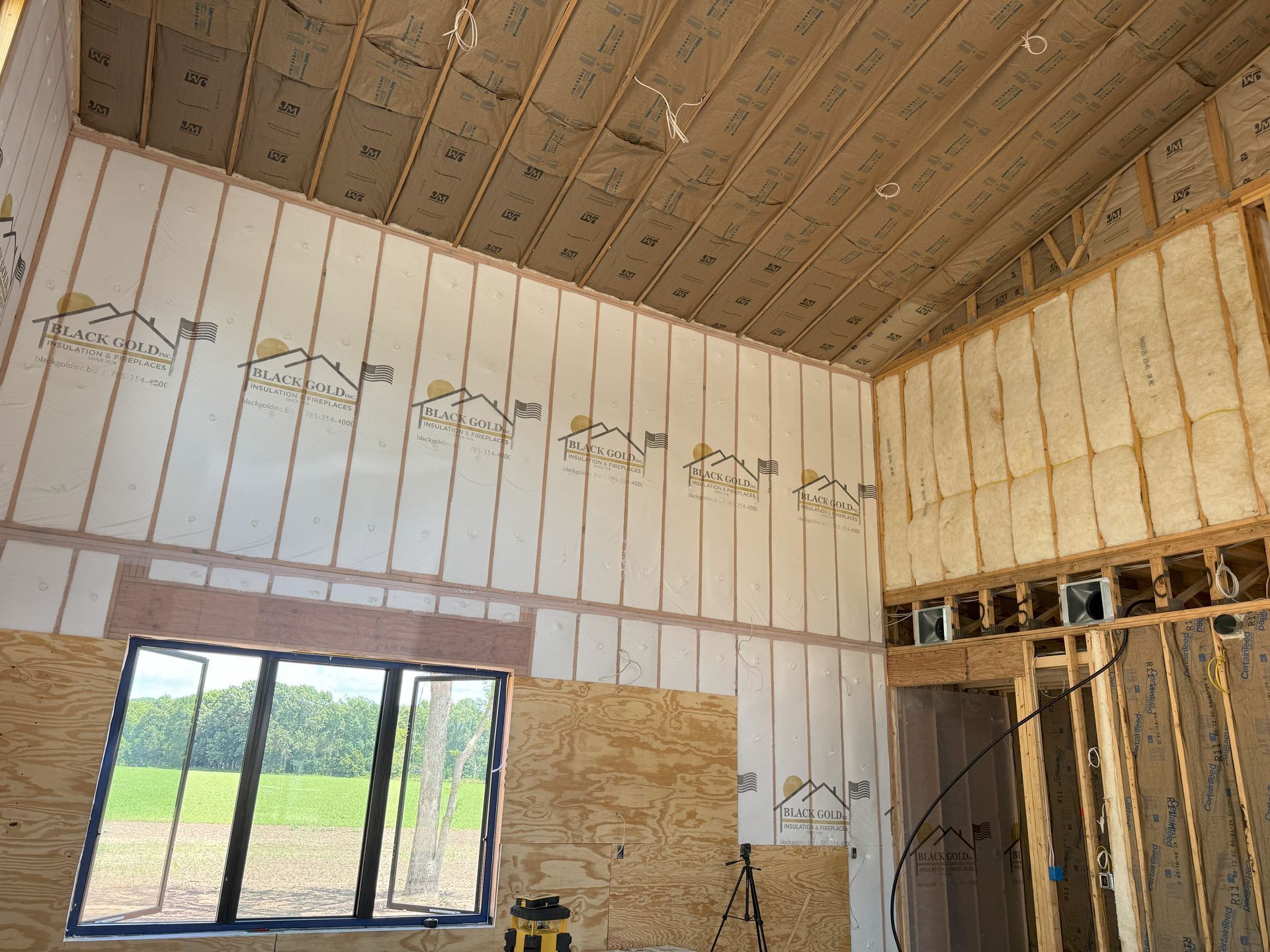 Man applying insulation on wall