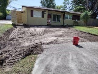 light yellow house with wooden gate before cement